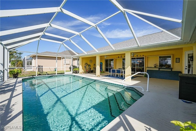 view of pool with a patio, a lanai, and ceiling fan