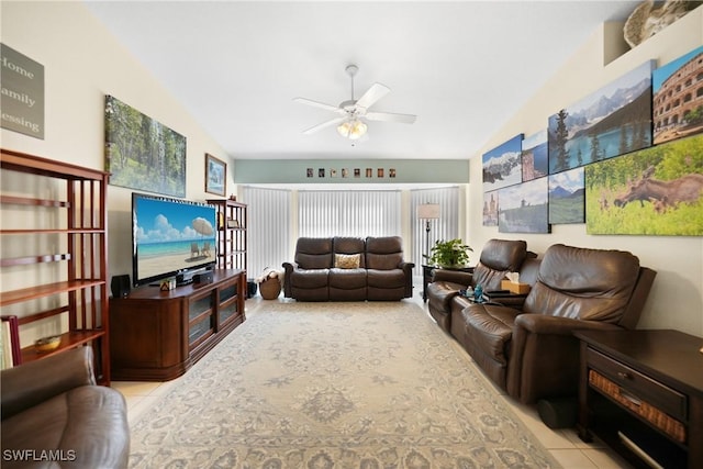 living room featuring ceiling fan, vaulted ceiling, and light tile patterned floors