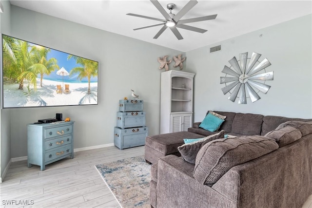 living room with light hardwood / wood-style floors and ceiling fan