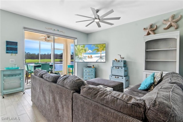 living room featuring ceiling fan and light hardwood / wood-style flooring