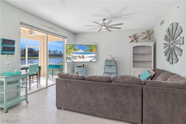 living room featuring ceiling fan and light hardwood / wood-style flooring