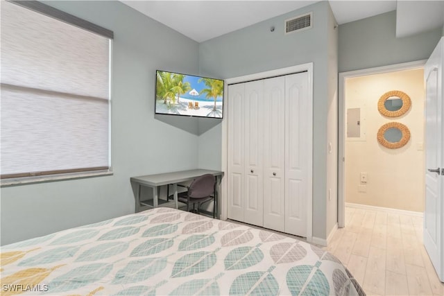 bedroom with a closet and light hardwood / wood-style floors