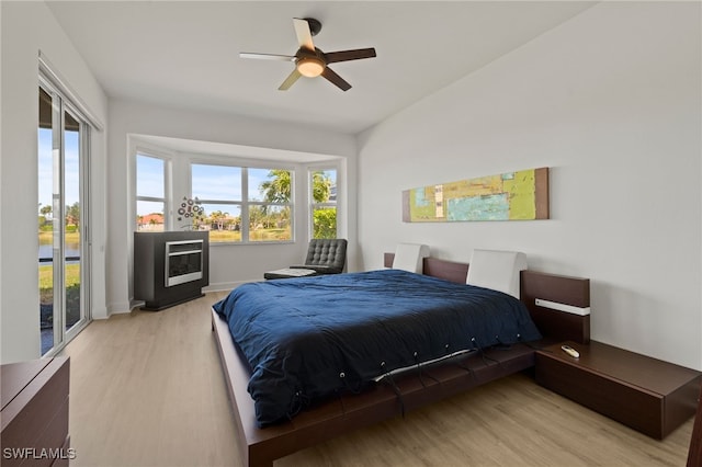 bedroom featuring access to outside, ceiling fan, and light hardwood / wood-style floors