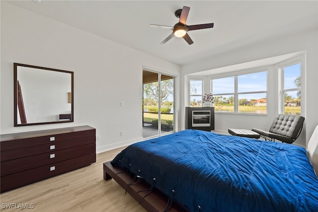 bedroom with access to outside, ceiling fan, and light hardwood / wood-style floors