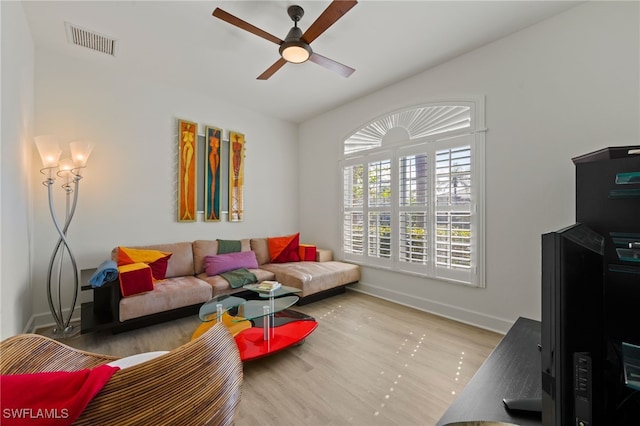 living room with ceiling fan and light hardwood / wood-style floors