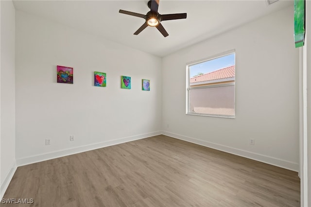 spare room featuring hardwood / wood-style floors and ceiling fan