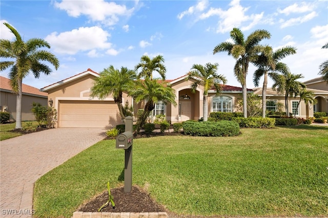 view of front of house featuring a garage and a front lawn