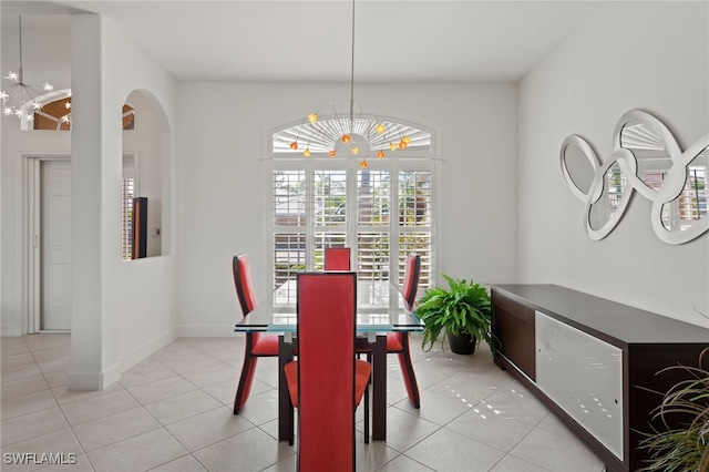 tiled dining space featuring a notable chandelier