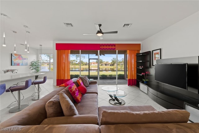 tiled living room with plenty of natural light and ceiling fan