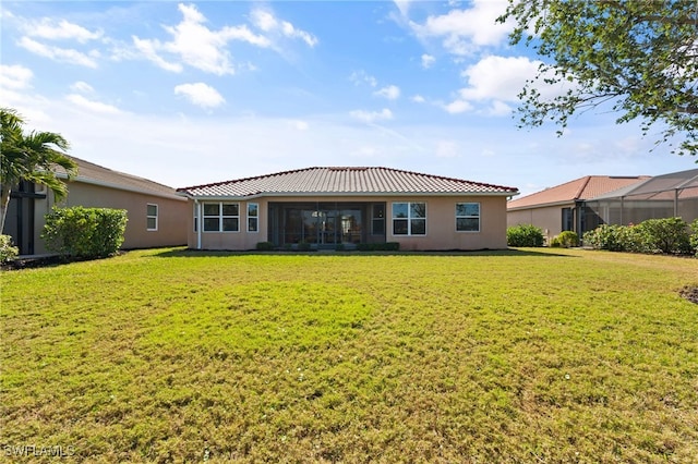 back of property featuring a yard