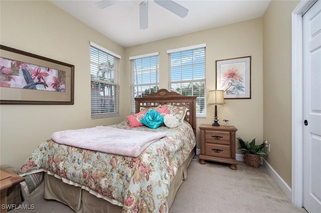 carpeted bedroom with ceiling fan and a closet