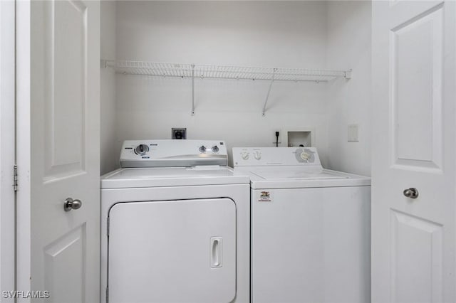 laundry room with independent washer and dryer