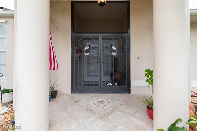 view of exterior entry featuring french doors