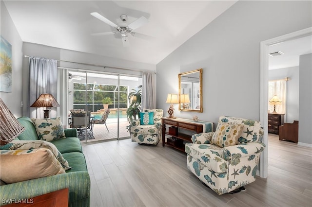 living room featuring light hardwood / wood-style floors, vaulted ceiling, and ceiling fan