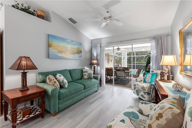 living room with light wood-type flooring, vaulted ceiling, and ceiling fan