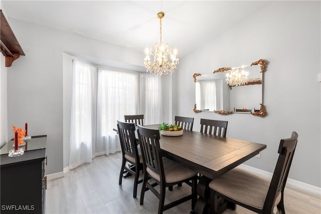 dining space featuring a notable chandelier and light wood-type flooring