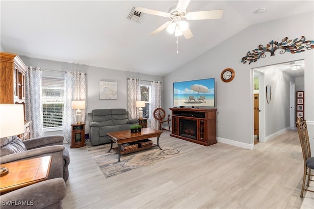 living room featuring ceiling fan, light hardwood / wood-style flooring, and lofted ceiling