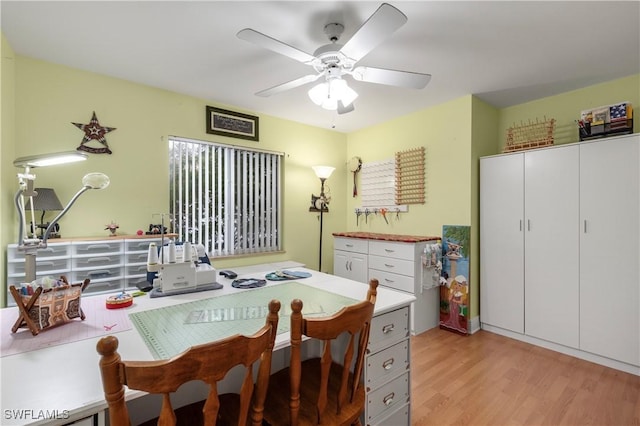 dining space featuring light wood-type flooring and ceiling fan