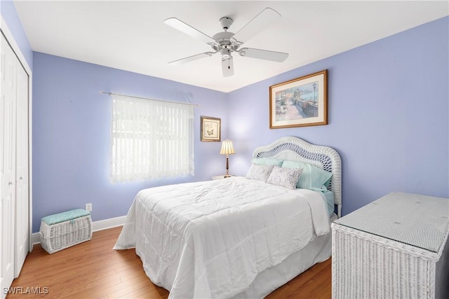 bedroom with ceiling fan, hardwood / wood-style flooring, and a closet