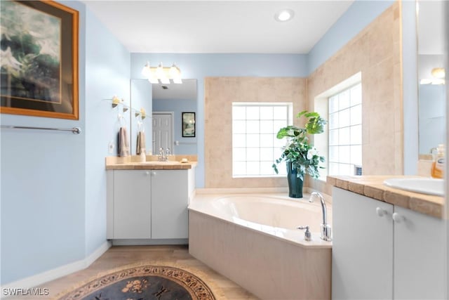 bathroom with a bathing tub and vanity