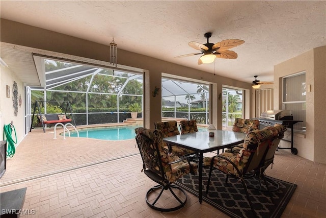 interior space with ceiling fan and area for grilling