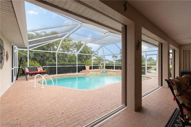 view of pool featuring an in ground hot tub, a lanai, and a patio