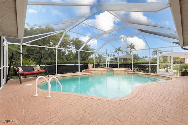 view of swimming pool featuring a patio area, a lanai, and an in ground hot tub