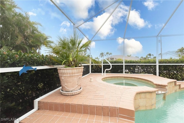 view of pool featuring an in ground hot tub and glass enclosure