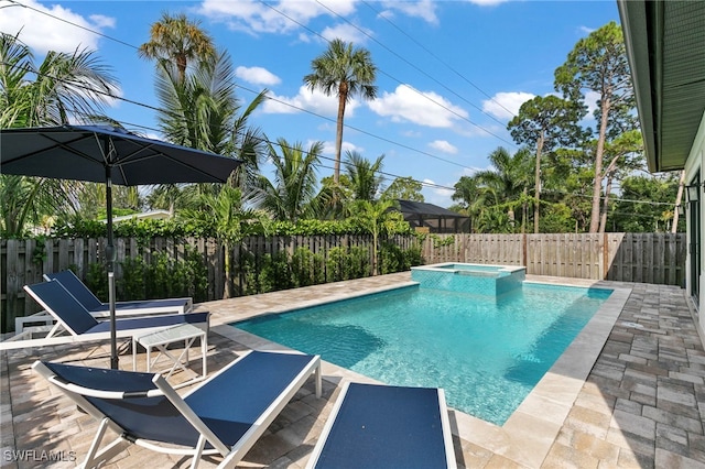 view of pool featuring a patio area and an in ground hot tub