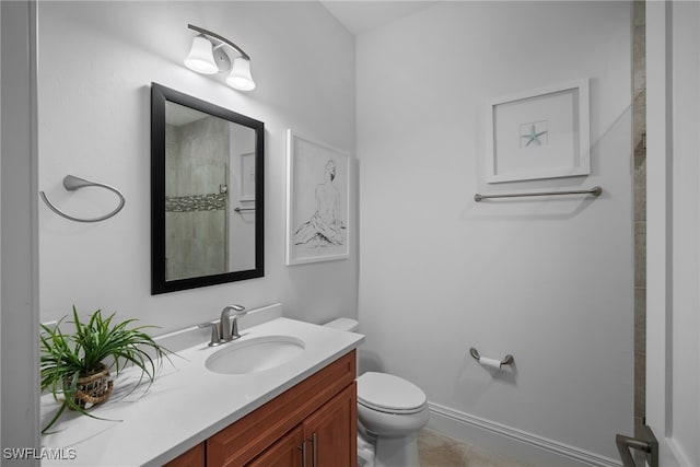 bathroom with vanity, tile patterned flooring, a shower, and toilet