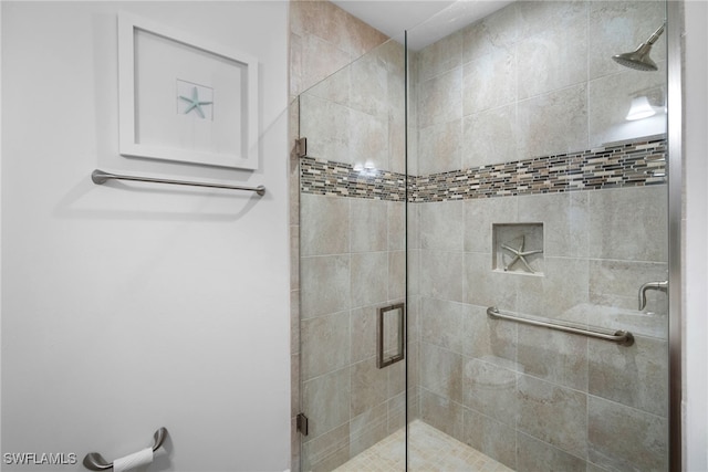 bathroom featuring a shower with shower door