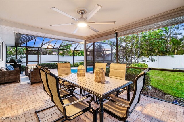 sunroom / solarium featuring a wealth of natural light and ceiling fan