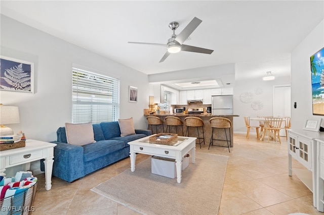 tiled living room featuring ceiling fan