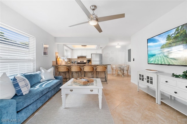 living room featuring ceiling fan and light tile patterned flooring