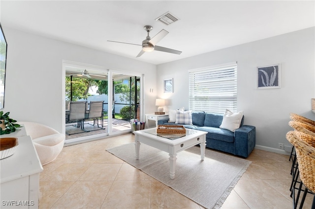 tiled living room featuring ceiling fan