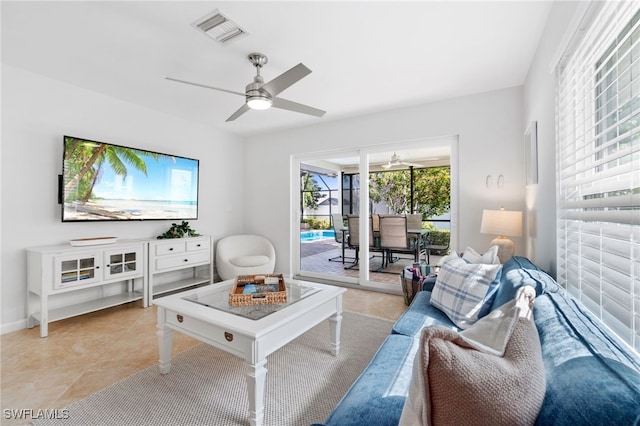 tiled living room with ceiling fan