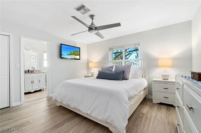 bedroom with ceiling fan, connected bathroom, and light hardwood / wood-style floors