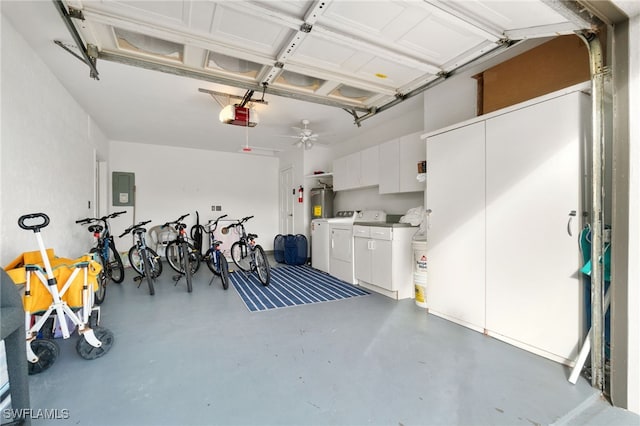 garage with separate washer and dryer, a garage door opener, and electric panel