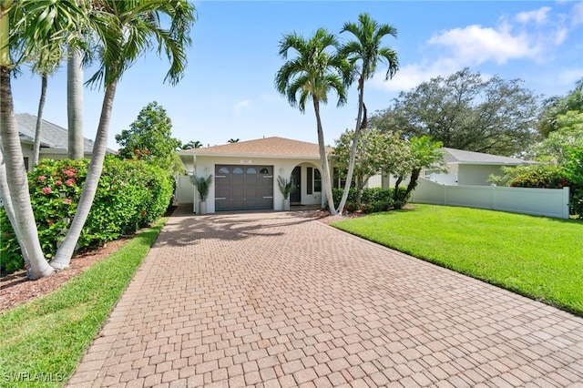 view of front of property featuring a garage and a front lawn