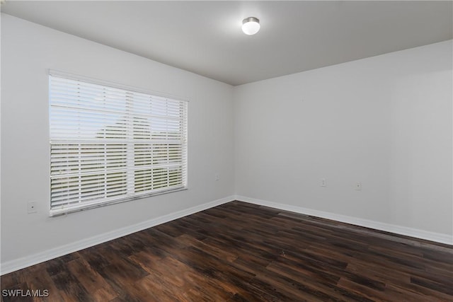 unfurnished room featuring dark wood-type flooring