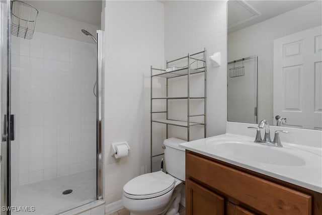 bathroom featuring vanity, toilet, and a shower with door