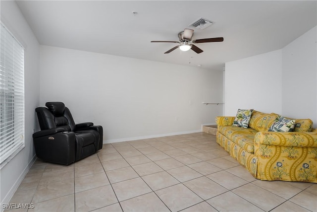 living area featuring light tile patterned floors and ceiling fan