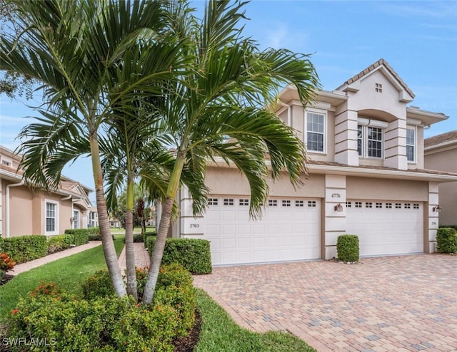 view of front of home with decorative driveway and stucco siding