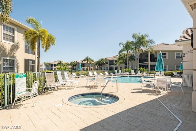 view of pool featuring a community hot tub and a patio