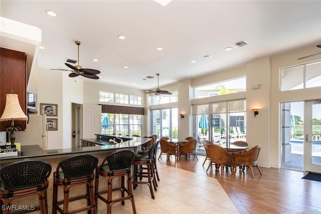 kitchen featuring a high ceiling, a wealth of natural light, and kitchen peninsula