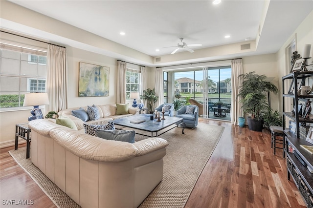 living room with ceiling fan and light hardwood / wood-style floors