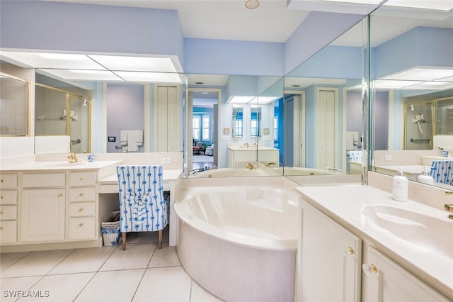 bathroom featuring shower with separate bathtub, tile patterned floors, and vanity