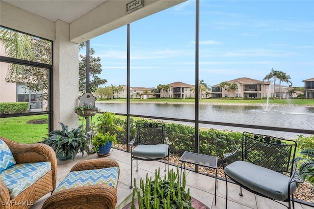 sunroom / solarium with a water view