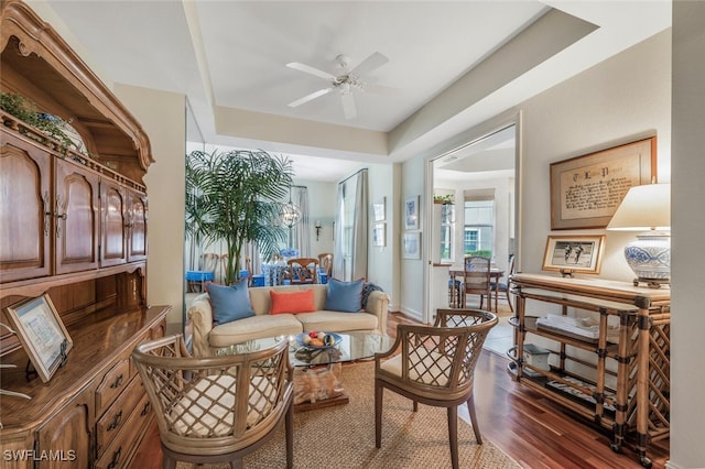 living area with dark hardwood / wood-style flooring and ceiling fan