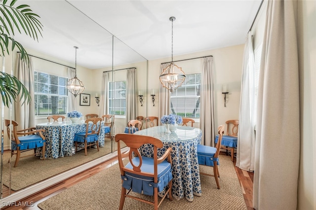 dining space with an inviting chandelier and wood-type flooring